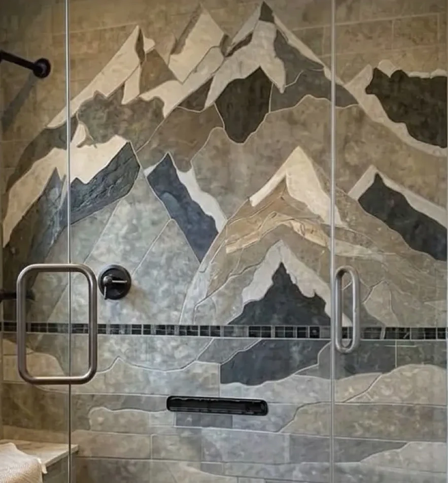 Hand-cut mountain mosaic in a shower, cropped to the artwork